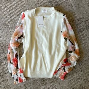 BNWT cream sweater with blouse floral arms. Size medium.